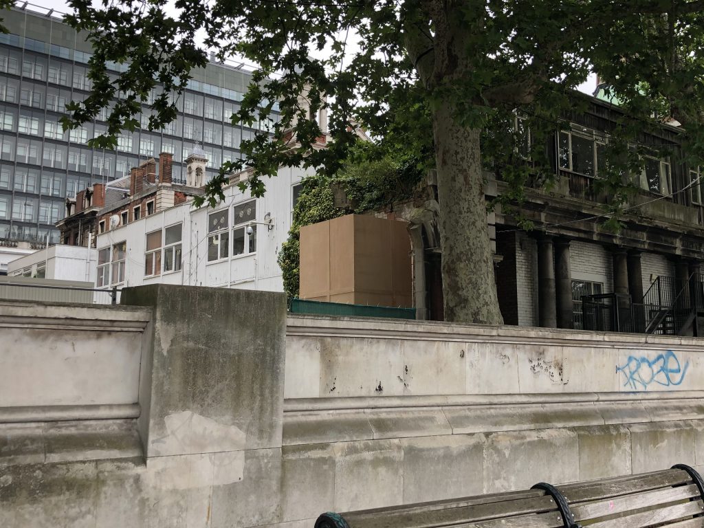 A nondescript hoarding surrounds the statue of Robert Clayton, now hidden from view  